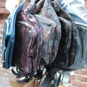 Puede incluir: Una colecci&oacute;n de cinco bolsos de diferentes patrones y colores s&oacute;lidos. Los bolsos est&aacute;n hechos de cuero y tienen una variedad de cierres, incluyendo cremalleras y hebillas. Los bolsos son todos en tonos de azul y negro.