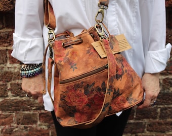 Floral printed suede leather strung bucket bag, Front zip, Small to medium size bag, Lightweight, Internal pockets, Two straps 1 adjustable