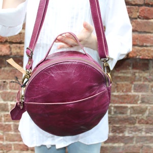 Circular purple leather handbag, Purple leather purse, Round handbag, Crossbody, Shoulder bag, Grab handle, Black lining, Pockets, Rupertbag