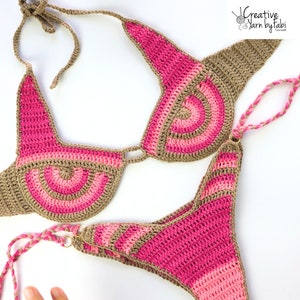 May include: A crocheted bikini set in pink and brown with a geometric pattern. The top has a halter style with a tie closure. The bottom is a high-cut style with a tie closure on the sides.