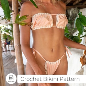 May include: A crochet bikini pattern in PDF format. The pattern features a pink bikini top with white crochet trim and a matching pink bikini bottom with white crochet trim.