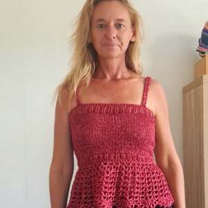 May include: A red crochet top with a fitted bodice and a ruffled hem.