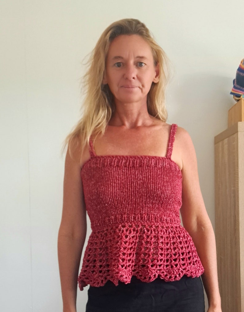 May include: A red crochet top with a fitted bodice and a ruffled hem.