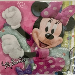 May include: Pink and white Minnie Mouse napkin with a polka dot pattern and the word "Minnie" printed on the bottom left corner.
