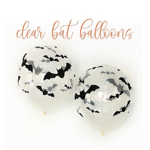 May include: Two clear balloons with black and gray bat silhouettes. The balloons have a white background and the text "clear bat balloons" in a cursive font.