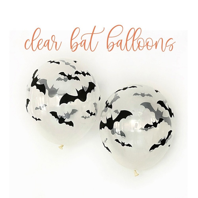 May include: Two clear balloons with black and gray bat silhouettes. The balloons have a white background and the text "clear bat balloons" in a cursive font.
