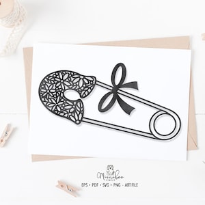 May include: Black and white digital cut file of a safety pin with a floral design. The pin has a bow on the top. The file is for crafting and can be used for a variety of projects.
