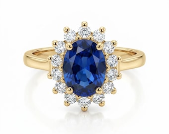 May include: A gold ring featuring a large, oval, deep blue gemstone surrounded by a halo of smaller, round, white gemstones. The ring's band is a simple, polished gold.