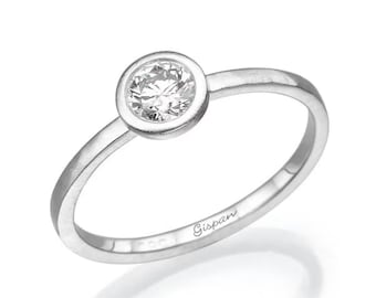 May include: A simple silver band ring with a bezel-set round diamond. The ring is inscribed with the word "Gispaan".