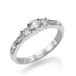 May include: A silver ring with three round diamonds set in a row. The ring is engraved with "14K Gisman" on the inside band.