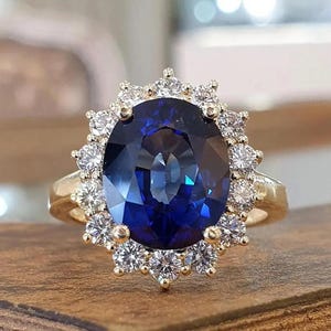 Princess Diana Inspired Ring: 4CT Oval Blue Sapphire, 14K Yellow Gold, Diamond Halo
