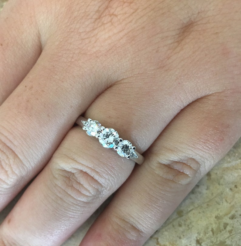 May include: A silver band with five round diamonds set in a graduated row.