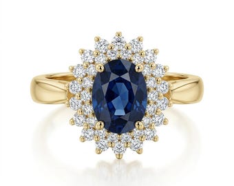 May include: A gold ring featuring a large, oval, deep blue gemstone surrounded by a halo of smaller, round, white gemstones. The ring's band is a polished gold color, and the setting is a classic design.