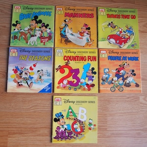 May include: A set of eight vintage Disney Discovery Series children's books featuring Mickey Mouse and his friends. The books cover topics such as baby animals, manners, things that go, the seasons, counting fun, and people at work.