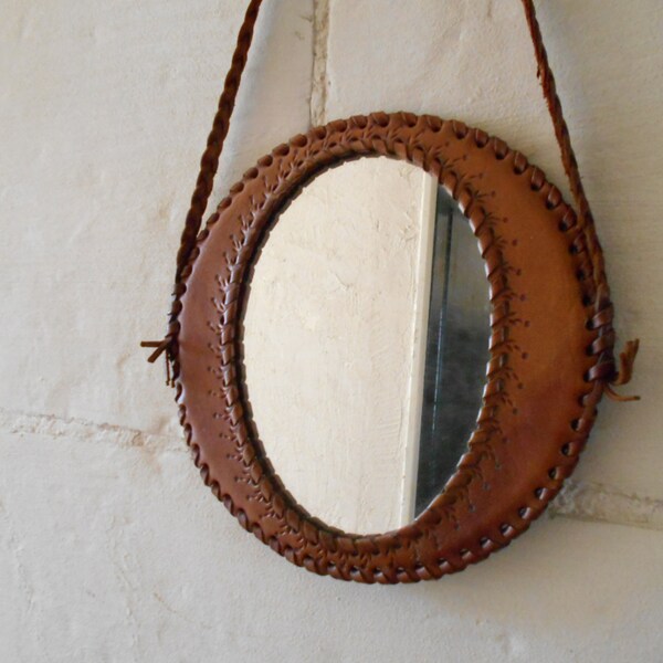 Vintage mirror with leather strap and cover.
