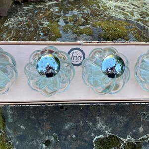 May include: Set of four clear glass salt and pepper shakers in a pink box. The shakers have a flower-like design and silver tops. The box has the text "Irice Products" printed on it.