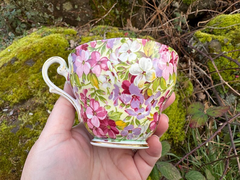 May include: A set of three ceramic mugs with a speckled, matte finish. The mugs are in shades of cream, light gray, and dark gray. Each mug has a simple, minimalist design, perfect for coffee or tea.