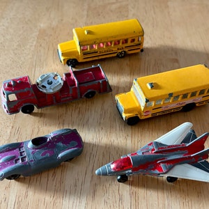 Vintage Lot of Diecast Metal Toy Vehicles:  Matchbox, Tomica and Tootsie Toys, 1960s-1980s  (Car, School Bus, Jet Plane, Firetruck)