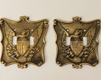 Placche copriinterruttore vintage in ottone massiccio con stemma dell'aquila americana, vendute separatamente.