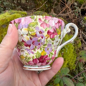 May include: A set of three ceramic mugs with a speckled, matte finish. The mugs are in shades of cream, light gray, and dark gray. Each mug has a simple, minimalist design and a rounded handle. Perfect for coffee or tea.
