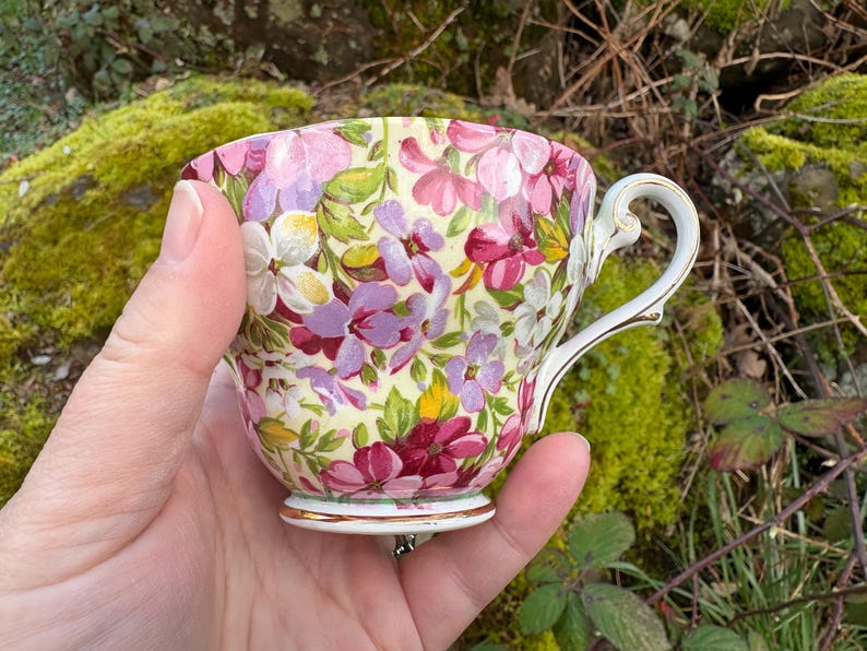 May include: A set of three ceramic mugs with a speckled, matte finish. The mugs are in shades of cream, light gray, and dark gray. Each mug has a simple, minimalist design and a rounded handle. Perfect for coffee or tea.