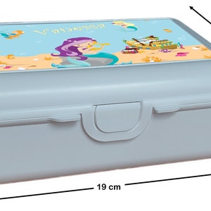 May include: A light blue lunchbox with a mermaid design. The lid features a mermaid with purple hair and a seashell, a ship, and the name "Vanessa". The lunchbox measures 7 inches tall, 13.9 inches wide, and 19 inches long.
