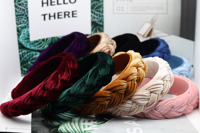 May include: Assortment of braided velvet headbands in various colors, including burgundy, green, gold, beige, pink, blue, and purple.