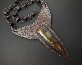 May include: A copper necklace with a textured, geometric design and a green and brown agate stone pendant.