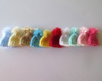 Hand-knitted hats for fashion dolls.