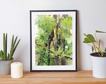 May include: A framed watercolor painting of a forest scene with green trees and a white background. The painting is in a black frame and is sitting on a wooden table with two potted plants.