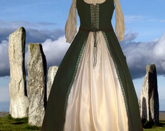 May include: A green and cream medieval-style dress with a lace-up bodice and a long skirt. The dress is photographed in front of a stone circle.