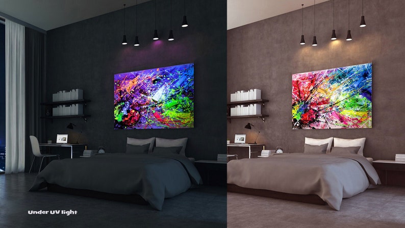 May include: A bedroom with a bed, a desk, and a large abstract painting on the wall. The painting is colorful and has a lot of different colors, including red, yellow, blue, green, and purple. The painting is lit up by a UV light, which makes the colors glow. The room is dark, and the only light is coming from the UV light and the lamps on the ceiling.