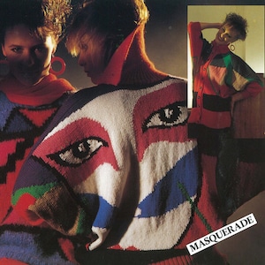 May include: Two women wearing colourful sweaters with a geometric design. The sweaters feature large eyes and a "MASQUERADE" label.