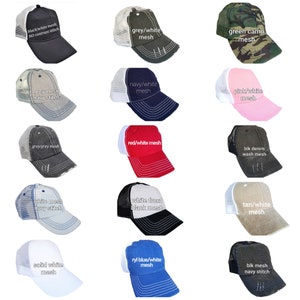 May include: A collection of 15 different trucker hats with various color combinations and mesh panels. The hats feature different text on the front, including "black/white mesh", "grey/white mesh", "green camo mesh", "grey mesh navy stitch", "navy/white mesh", "pink/white mesh", "grey/grey mesh", "red/white mesh", "blk denim wash mesh", "white mesh navy stitch", "white front black mesh", "tan/white mesh", "solid white mesh", "ryl blue/white mesh", and "blk mesh navy stitch".