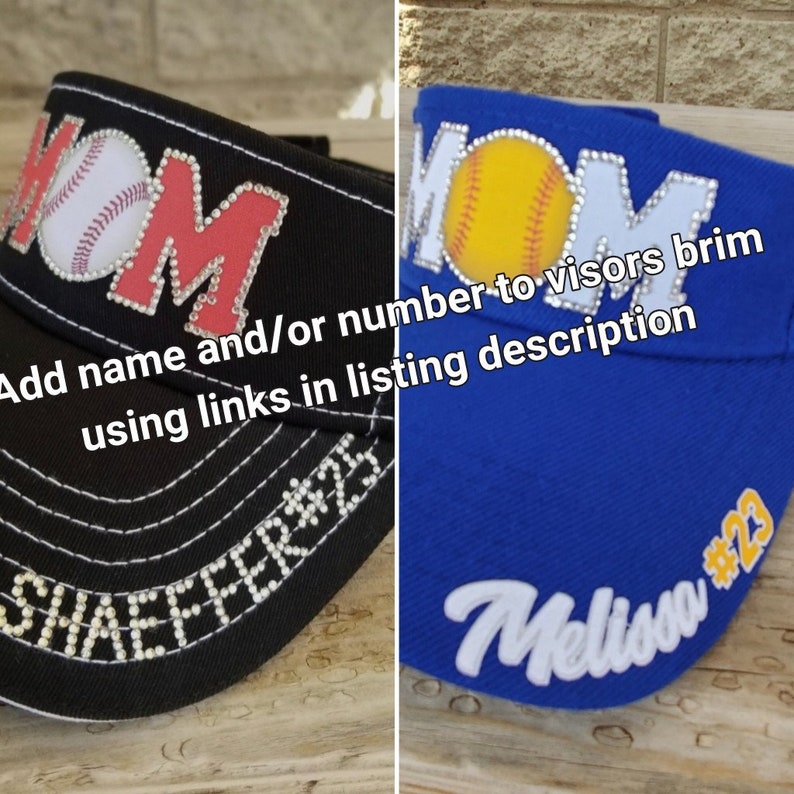 May include: Two black and blue baseball caps with rhinestones spelling out "MOM" and a baseball graphic. The brim of each cap has a name and number in rhinestones. The text on the image reads "Add name and/or number to visors brim using links in listing description".
