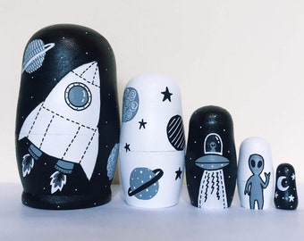 Monochrome space nesting dolls, black and white rocket Russian dolls