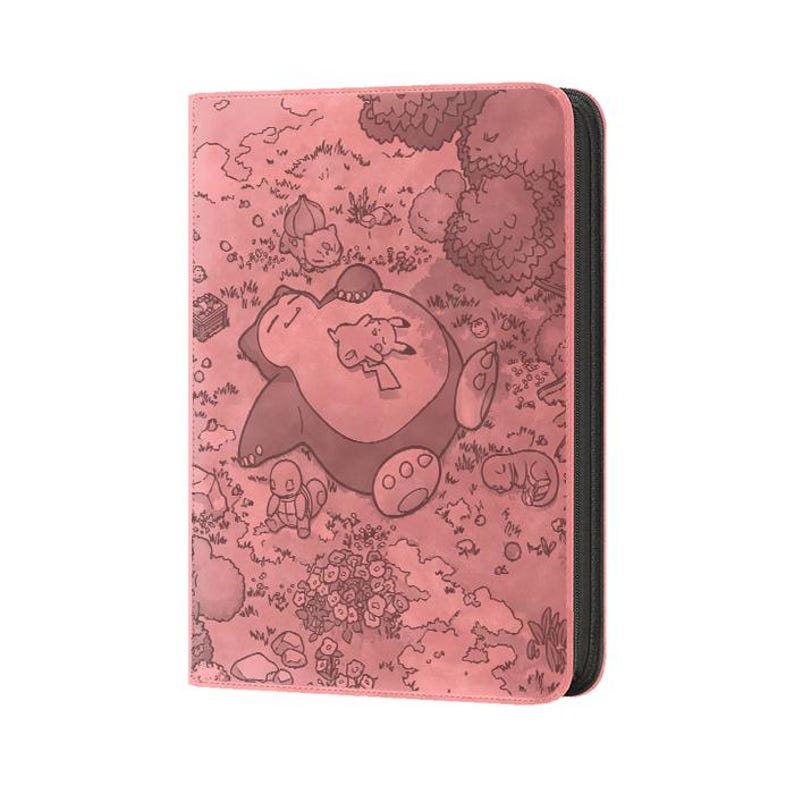 May include: A pink card binder featuring a detailed illustration of a sleeping Snorlax with Pikachu and other Pok&eacute;mon characters in a forest scene. The binder has a black spine and a zipper closure, perfect for storing trading cards.