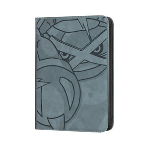 May include: A gray, zippered card holder featuring a stylized illustration of a character with a cross-shaped design and sharp eyes. The design is outlined in black against a textured background. The card holder has a black border.