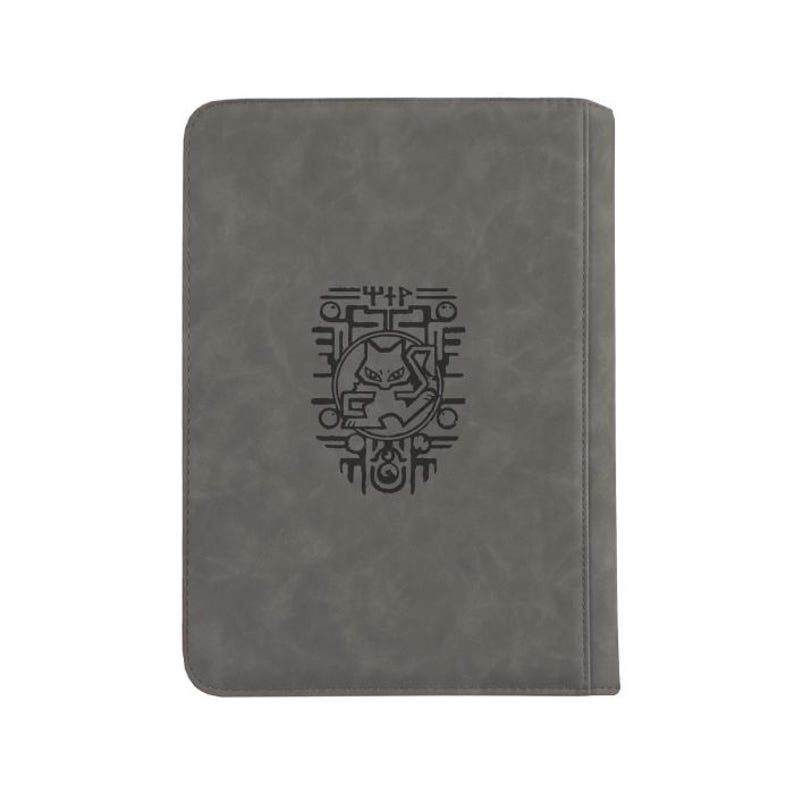 May include: A rectangular gray notebook with a smooth, matte finish. Centered on the front cover is a black graphic illustration featuring a stylized cat-like creature enclosed within a circular frame, surrounded by geometric line patterns.