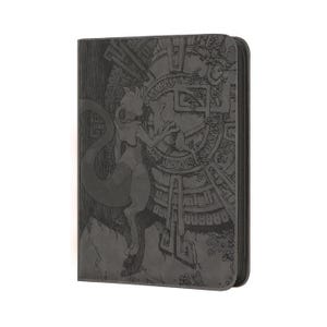May include: A dark gray zippered binder featuring an embossed graphic of a bipedal creature with a long tail standing before a large circular stone-like structure with intricate geometric patterns and ancient-looking symbols etched into the surface.