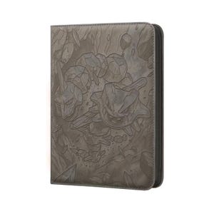 May include: Gray zippered binder featuring embossed artwork of a rock-type creature. The cover design includes detailed illustrations of the creature and rock formations. The binder has a black zipper and a textured surface.
