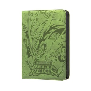 May include: A light green rectangular trading card binder with a black zipper closure. The front cover features a dark green line art illustration of a creature and the text Mega Evolution Delta Reign embossed in a stylized font on the lower half.