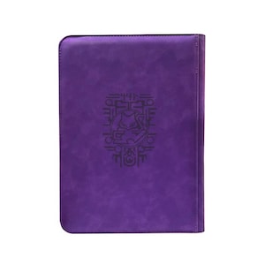 May include: A rectangular purple binder with rounded corners featuring a dark purple embossed graphic of a stylized creature centered on the front cover. The surface has a smooth, matte texture with visible stitching along the right edge.