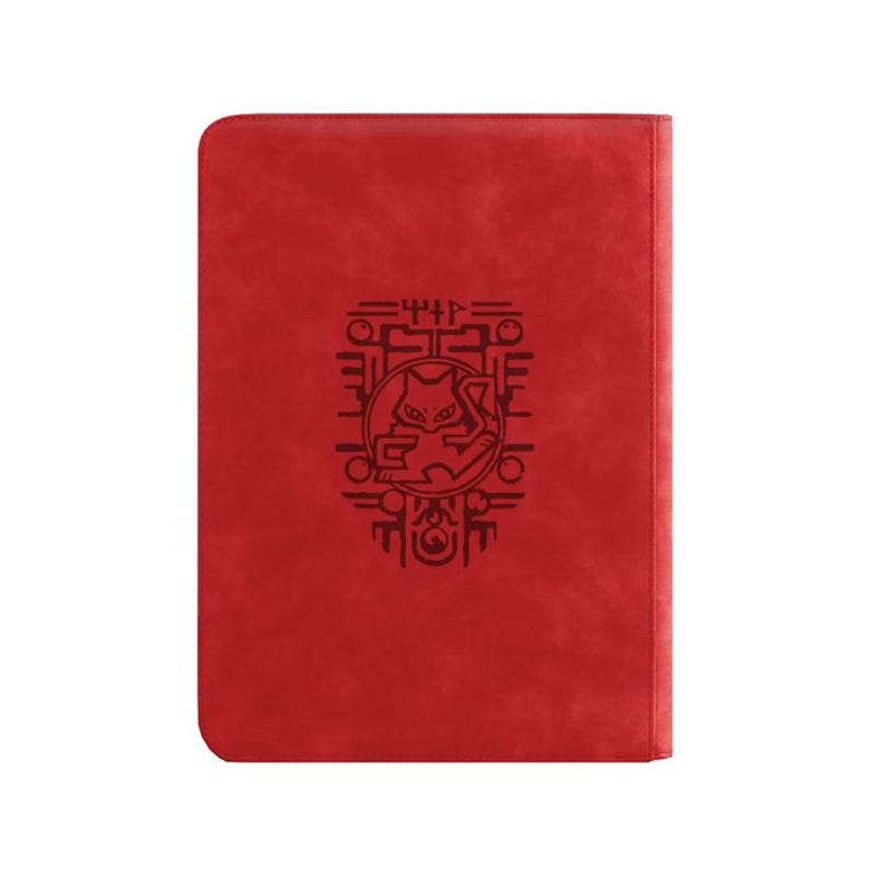 May include: A rectangular red notebook with a smooth, matte finish. Centered on the front cover is a black, intricate graphic design featuring a stylized feline creature enclosed within a circular frame, surrounded by geometric patterns and symbols.