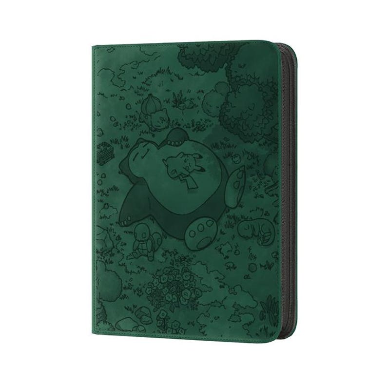 May include: A dark green card binder featuring an embossed design of a sleeping Snorlax with Pikachu and other Pok&eacute;mon characters in a forest scene. The binder has a black zipper closure and a textured surface.