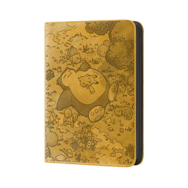 May include: A tan card binder featuring a detailed illustration of a sleeping Snorlax with Pikachu and other Pok&eacute;mon characters in a grassy field. The binder has a black zipper and a textured surface.