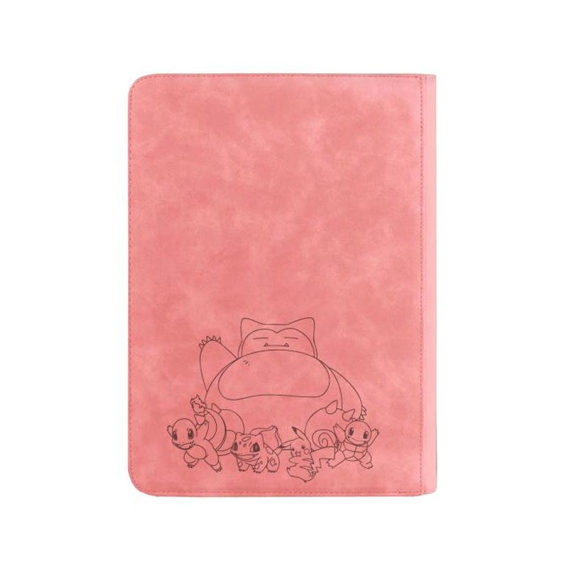 May include: Pink faux leather binder featuring a black line drawing of a Snorlax and other Pok&eacute;mon characters. The binder has a textured surface and a stitched border.