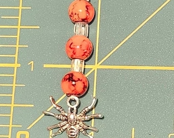 spider with orange beads zipper pull