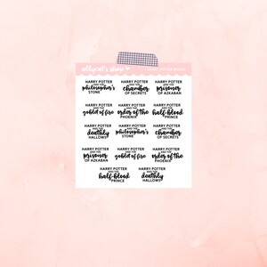 May include: A set of 12 Harry Potter book title stickers. The stickers are white with black text and feature the titles of each book in the series. The stickers are arranged in a grid pattern on a pink background.
