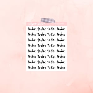 May include: A sheet of black and white to-do list stickers with the text "to do" repeated multiple times. The stickers are on a pink background.